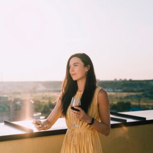 beautiful-woman-drinking-wine-rooftop-sunlight_23-2148266860